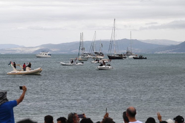 Supporters and activists of the Global Sumud Flotilla gather at the Tunisian port of Sidi Bou Said, ahead of the scheduled departure to the Gaza Strip to break Israel's blockade on the Palestinian territory on September 10, 2025. Organizers of the flotilla named 'Sumud', an Arabic word meaning steadfastness, which carries aid and pro-Palestinian activists, said late September 9 that another of their boats had been struck in a suspected drone attack off Tunisia's coast. 