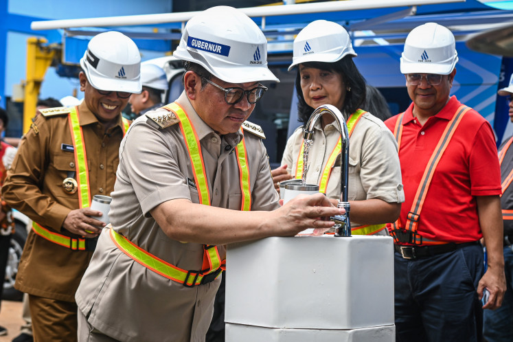 Jakarta Governor Pramono Anung (front) fills a cup with purified drinking water on Sept. 9, 2025, at the Pesanggrahan Water Treatment Plant (IPA) in Lebak Bulus, South Jakarta, as Banten Governor Andra Soni (left), Deputy Public Works Minister Diana Kusumastuti (second right) and PAM Jaya president director Arief Nasrudin look on. The Pesanggrahan plant has the capacity to supply drinking water at a rate of 750 liters per second via 75,000 new pipeline connections in 10 subdistricts in Jakarta, as well as fulfill water needs in South Tangerang, Banten.