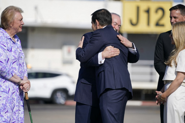 US Secretary of State Marco Rubio is greeted upon his arrival by US Ambassador to Israel Mike Huckabee, at Ben Gurion International Airport on September 14, 2025. 