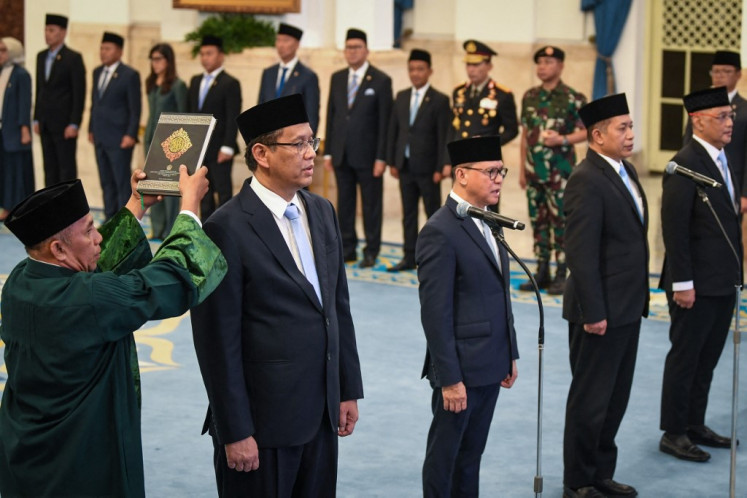 Newly appointed Finance Minister Purbaya Yudhi Sadewa (2nd left), Minister for the Protection of Indonesian Migrant Workers Mukhtaruddin (3rd left), Minister of Cooperatives Ferry Juliantono (4th left), and Minister of Haj and Umrah Mochamad Irfan Yusuf (right) attend their swearing-in ceremony at the Presidential Palace in Jakarta on September 8, 2025. 