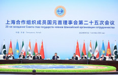 China's President Xi Jinping (center) attends the Shanghai Cooperation Organisation (SCO) in Tianjin on Sept. 1, 2025, in this photograph distributed by the Russian state agency Sputnik.
