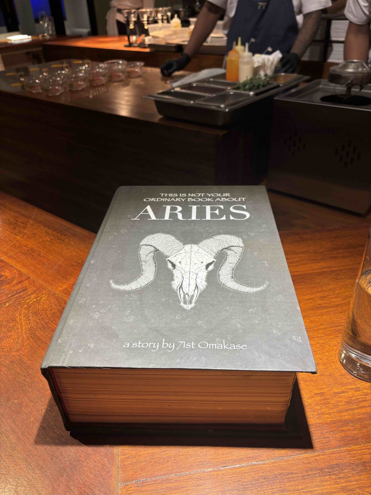 A book opens to reveal beef pastry crowned with a ram horn, Aries’ fiery introduction.