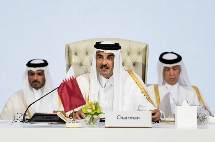 This handout picture released by the he Qatar News Agency (QNA) shows Qatar's Emir Sheikh Tamim bin Hamad Al-Thani (center) chairing the 2025 Arab-Islamic emergency summit in Doha on September 15, 2025.  