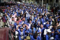Students from several universities take part in a protest against the parliaments planned purchase of 65 SUVs for lawmakers on a street in Dili, Timor Leste, on September 15, 2025. 