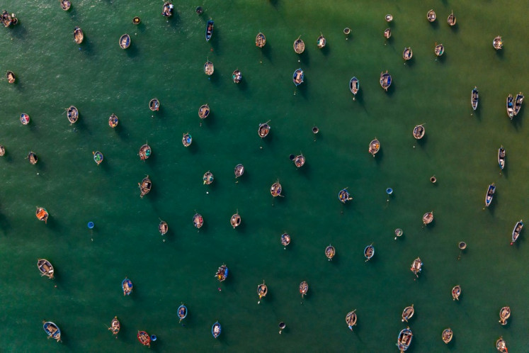 This aerial picture taken on June 29, 2024 shows fishing boats moored at a beach in Danang, central Vietnam.