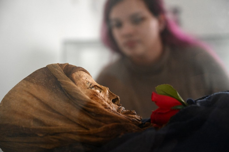 Daniela Betancourt, researcher of the National University, observes a mummy in the Jose Arquimedes Castro mausoleum museum, located at the cemetery in San Bernardo municipality, Cundinamarca department, Colombia on April 10, 2024. 