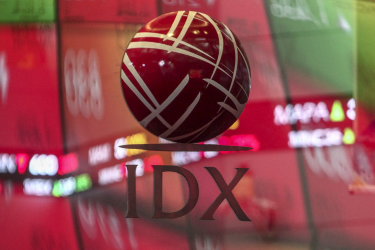 The Indonesia Stock Exchange (IDX) logo is pictured at the bourse's building in Jakarta, on March 13. Not deterred by the pandemic-induced market volatility, the number of retail investors in Indonesia’s stock market continues to rise with new investors hopeful of reaping future profits from today’s low base, providing a buffer for the local bourse as foreign investors dump risky assets. 