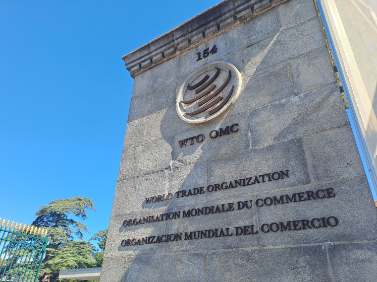 A pillar at the front gate to the World Trade Organization's headquarters shines under the sun on Sept. 15 in Geneva, Switzerland.