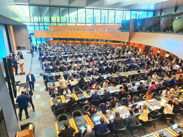 Participants gather at the World Trade Organization's (WTO) main conference room in its Geneva headquarter for the opening plenary of the WTO Public Forum on Sep. 17, 2025.