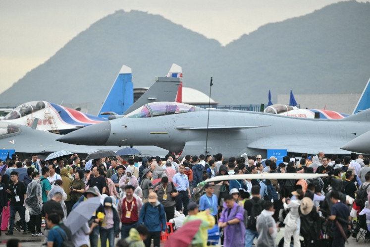Visitors are seen near the Chinese-made Chengdu J-10 Vigorous Dragon fighter jet during the 15th China International Aviation and Aerospace Exhibition on Nov. 14, 2024, in Zhuhai, in southern China's Guangdong province.