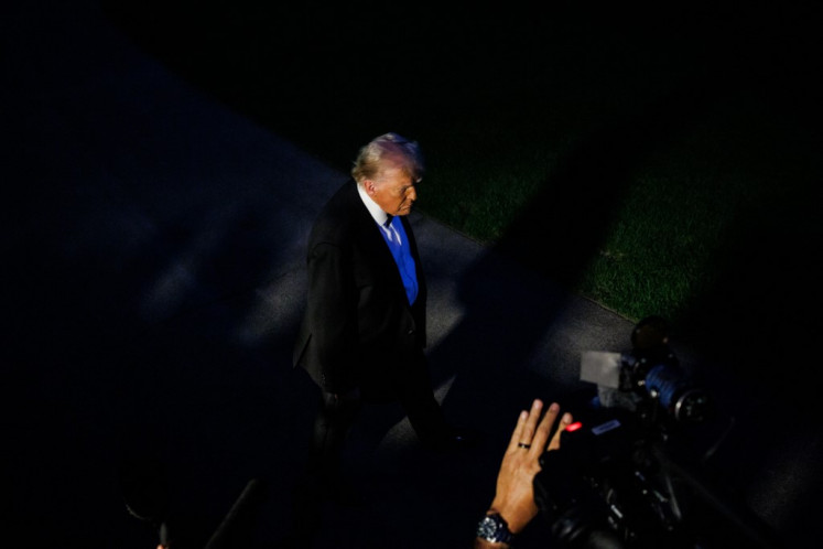 President Donald Trump speaks with reporters before departing from the South Lawn of the White House in Marine One on September 20, 2025 in Washington, DC. 