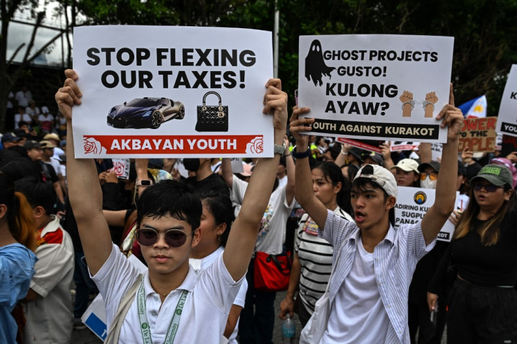 Protesters take part in a rally as they demonstrate against corruption following the revelations over bogus flood control projects, one of the country's biggest corruption scandals in decades, at the People Power Monument in Quezon City, Metro Manila on September 21, 2025. 