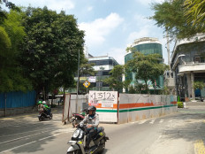 Motorcyclists travel along a street on Monday in Cikini, Central Jakarta, where utility work for a new sewerage system has cut through the road.