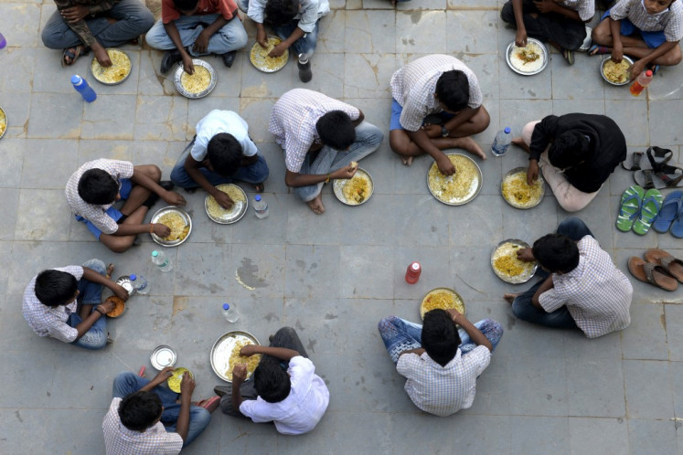 Students eat their mid-day meal during lunch break at a government high school on the outskirts of Hyderabad, India, on Nov. 23, 2021.