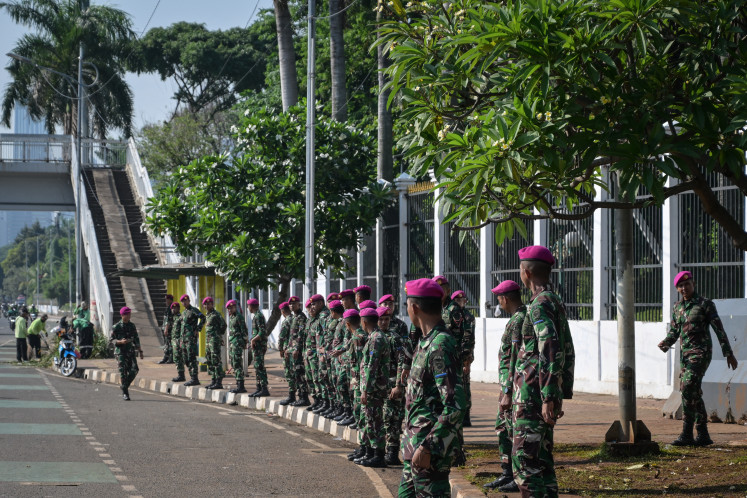 Marines secure positions along a street on Sept. 1 outside the Senayan legislative complex in Jakarta. 
