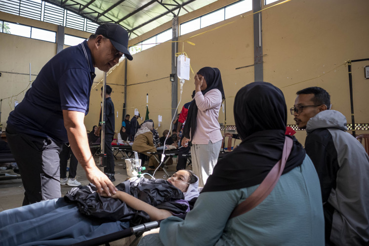 Food scare: National Nutrition Agency (BGN) head Dadan Hindayana (left) speaks with a student affected by food poisoning after consuming a school meal on Tuesday in Cipongkor, West Bandung, West Java.