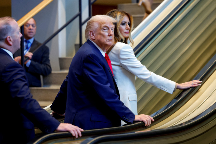  US President Donald Trump and first lady Melania Trump ride an escalator as they arrive to attend the 80th United Nations General Assembly, in New York, US on September 23, 2025. 