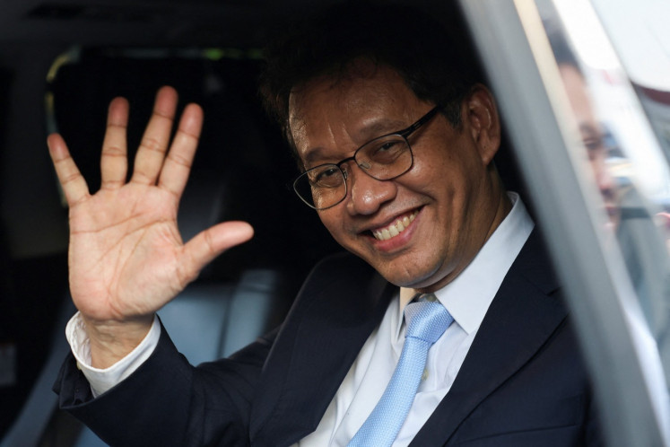Newly appointed Finance Minister Purbaya Yudhi Sadewa waves to journalists following his inauguration on Sept. 8 at the Presidential Palace in Jakarta. 