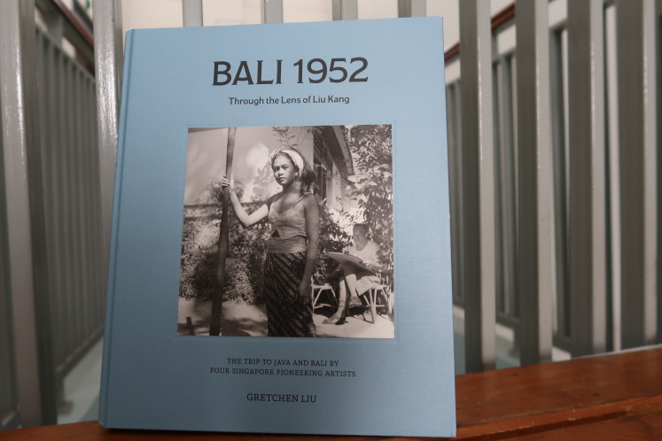 Book of memories: The blue-covered Bali 1952: Through the Lens of Liu Kang, written by Liu's daughter-in-law Gretchen Liu, documents his seven-week trip to Indonesia, is seen in this photo created on Tuesday. (JP/Nur Janti)