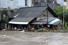A house is inundated by floodwaters on Sept. 10 following heavy rain in Denpasar, Bali.