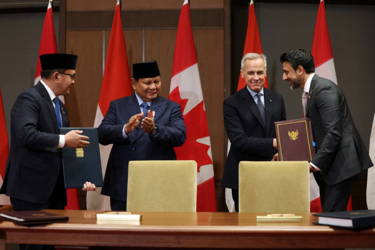Canadian Prime Minister Mark Carney (second right) shakes hands with Canadian Minister of International Trade Maninder Sidhu (right) as President Prabowo Subianto (second left) and Trade Minister Budi Santoso (left) look on during the signing of the Indonesia-Canada Comprehensive Economic Partnership Agreement (ICA-CEPA) on Parliament Hill in Ottawa, Canada, on Sept. 24, 2025.