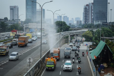 Jakarta Environmental Agency workers spray mist on Sept. 19, along Jl. TB Simatupang in South Jakarta. The agency sprayed 4,000 liters of mist at several strategic points to reduce air pollution in an attempt to clean the cities air ahead of Jakarta Eco Future Fest (JEFF) 2025.