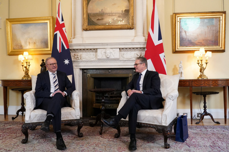 Britain's Prime Minister Keir Starmer listens to his Australian counterpart Anthony Albanese inside 10 Downing Street in London, Britain, on Sept. 26, 2025.