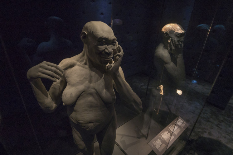 An exhibit shows a reconstruction of Homo erectus next to fossils of Homo erectus' skull cap and femur unearthed by Dutch geologist Eugene Dubois in Java in 1891 on display at the Naturalis Biodiversity Center in Leiden, the Netherlands, in this undated photo.