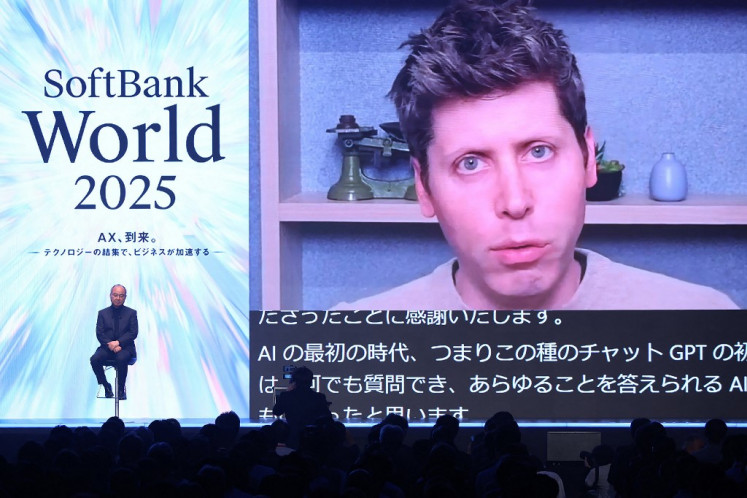 Masayoshi Son (left), chairman and president of SoftBank Group, talks on July 16 with CEO of United States company OpenAI Sam Altman (right) via video chat at a SoftBank World 2025 lecture in Tokyo. 