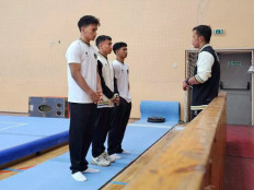 Indonesian gymanstics coach M. Tri Saputra (right) briefs Men's Artistic Gymnastics (MAG) athletes ahead of the FIG World Challenge Cup 2025 in Szombathely, Hungary, in this picture released by the Indonesian Gymnastics Federation on Friday. The Indonesian MAG team kept on fighting despite losing their teammate Naufal Takdir Al Bari, who passed away on Thursday after being treated for 12 days because of a neck injury in Russia. 