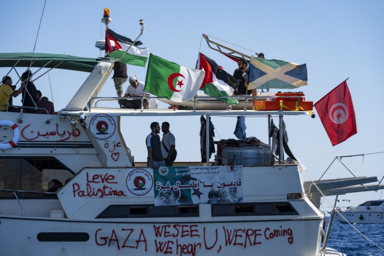 Members of the group of ships of the Global Sumud Flotilla to Gaza are seen moored at the small island of Koufonisi, south of the island of Crete, on September 26, 2025. 