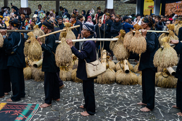 Members of the Kasepuhan Cisungsang indigenous community carry newly harvested rice to be placed in a leuit or rice barn during a Seren Taun traditional ceremony in Cisungsang, Lebak, Banten, on Sept. 29, 2025.