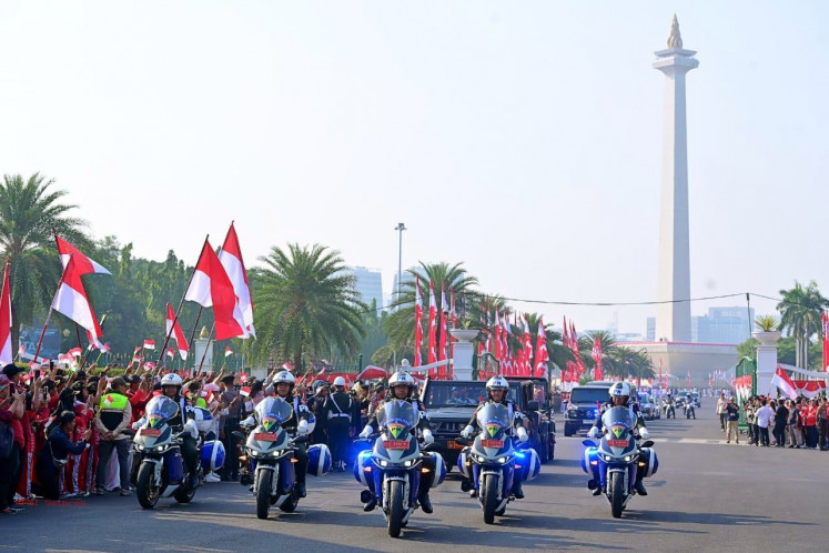 Lead the way: Police motorcades escort vehicles carry replicas of the red-and-white flags and the text of the proclamation on Aug. 10, 2024, at the National Monument (Monas) in Central Jakarta.