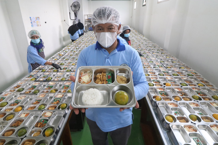 Safe plates: A staff member displays a free nutritious meal program meal platter on Sept. 30 during the launch of the nutritional fulfillment service unit (SPPG), at Al Amien Islamic Boarding School in Kediri, East Java.