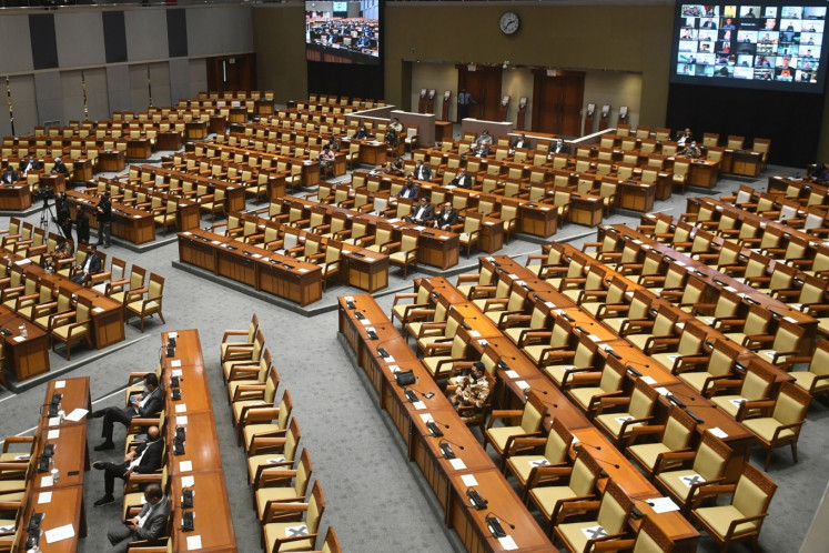 Some lawmakers of the House of Representatives attend the plenary meeting on the endorsement for 2019 state budget implementation bill (P2APBN) in the House's complex in Senayan, Central Jakarta while others joined the meeting virtually on Sept. 15. 