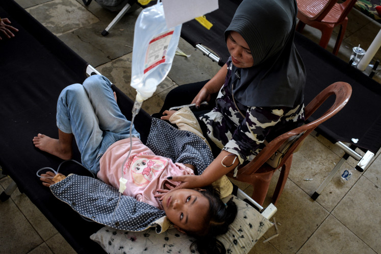 Salwa Nur Azmi, an elementary school student gets treatment in a makeshift clinic whilst she is suffering from food poisoning, after eating free meals provided by the government, in Bandung, West Java, on Sept. 23, 2025.
