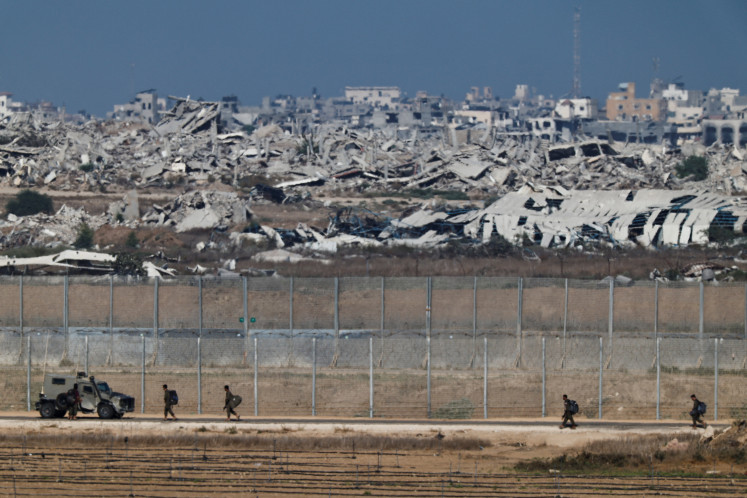Israeli soldiers patrol the Israeli side of the Israel-Gaza border on Sept. 30, 2025. 