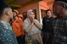 Relatives of missing students gather as search and rescue operations continue at Al Khoziny Islamic boarding school in Sidoarjo, East Java, on October 1, 2025, after the multi-story school building collapsed two days earlier. Around 91 people are believed to be still trapped under the ruins of a collapsed school, National Disaster and Mitigation Agency spokesperson Abdul Muhari said.