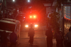 Medical personnel transport rescued students in an ambulance from a collapsed boarding school in Sidoarjo, East Java on Oct. 1, 2025. 