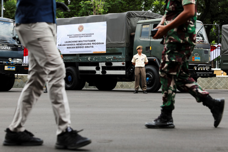 An Indonesian military officer stands beside a truck carrying multivitamins to be used in the government's free meal program before launch in Jakarta on Oct. 1, 2025.  (Reuters/Ajeng Dinar Ulfiana).
Usage: 0