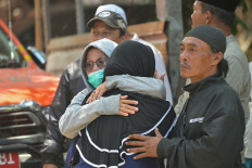 Relatives of missing students embrace as search and rescue operations continue at Al Khoziny Islamic boarding school in Sidoarjo, East Java on Oct.1, 2025, after the multi-story school building collapsed two days earlier. 