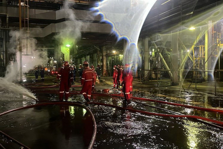 Emergency personnel extinguish a fire on Oct. 1 at PT Kilang Pertamina Internasional (KPI) refinery in Dumai, Riau. State-owned energy giant PT Pertamina guaranteed that fuel supplies throughout the Northern Sumatra region are unaffected by the fire. 