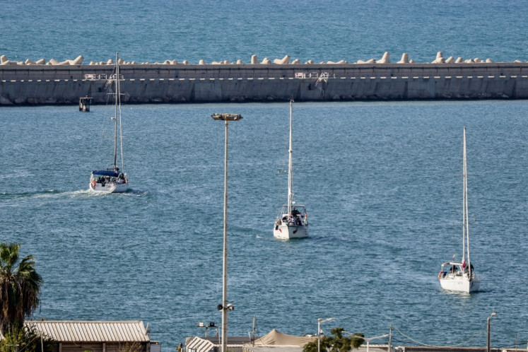 Boats from the Global Sumud Flotilla intercepted by Israeli forces in the Mediterranean sea off the Gaza Strip waters, arrive in the southern port of Ashdod on October 2, 2025. Israel said on October 2 it will deport pro-Palestinian activists aboard the intercepted Sumud Flotilla of around 45 vessels, which began its voyage a month earlier to deliver aid to Gaza, where a famine was declared by the United Nations. 