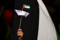 A person holds a paper boat on Thursday during a protest to condemn Israel's interception of Global Sumud Flotilla vessels aiming to reach Gaza and break Israel's naval blockade, in Rome. 