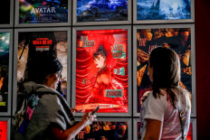 Fans take pictures in the lobby as they attend “Taylor Swift: The Official Release Party of a Showgirl“ at AMC Montgomery 16 movie theater in Bethesda, Maryland on October 3, 2025. To go alongside the 12-track album -- already the most streamed release of 2025 -- fans in dozens of countries are packing theaters for an accompanying film that is being released for three days only.