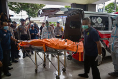 The remains of a student killed in a building collapse at the Al Khoziny Islamic boarding school is brought in a body bag to the Bhayangkara hospital in Surabaya, East Java on Oct. 4, 2025. The death toll in a school collapse rose to 17 on Oct. 4, officials said, as rescuers deployed heavy machinery to recover dozens more victims believed still buried under the rubble.