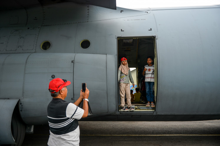 Children take a photo aboard a Hercules military aircraft on Oct. 5, 2025, during an open day at the Indonesian Air Force base at Husein Sastranegara Airport in Bandung, West Java.