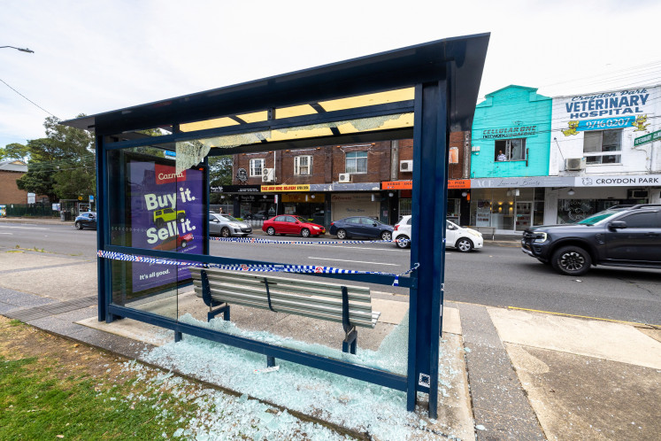 Police cordon off a waiting station at the site of a shooting incident, where multiple people were wounded on Sunday, in Croydon Park in Sydney, Australia, October 6, 2025. 