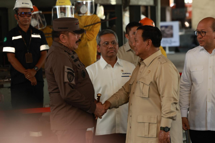 President Prabowo Subianto (second right) shakes hands with Attorney General ST Burhanuddin (left) during a ceremony marking the handover of Rp 7 trillion (US$440 million) in assets seized from corruption cases involving tin mining and rare earth extraction.
