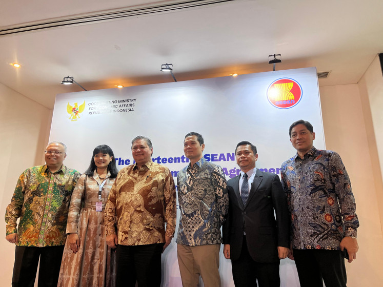 Coordinating Economy Minister Airlangga Hartanto (three from the left) pose for a picture with ASEAN representatives following a press conference on the ASEAN Digital Economy Framework Agreement (DEFA) 14th negotiations round in Jakarta on Oct. 7, 2025.